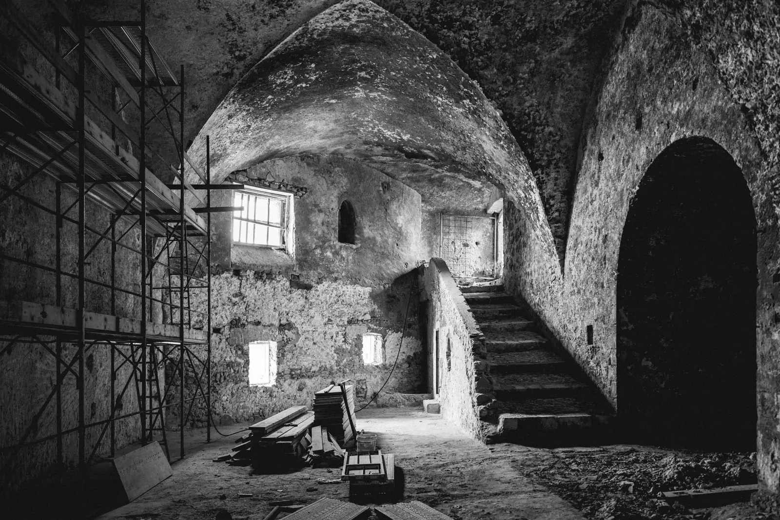 Vaulted interior with a staircase and scaffolding