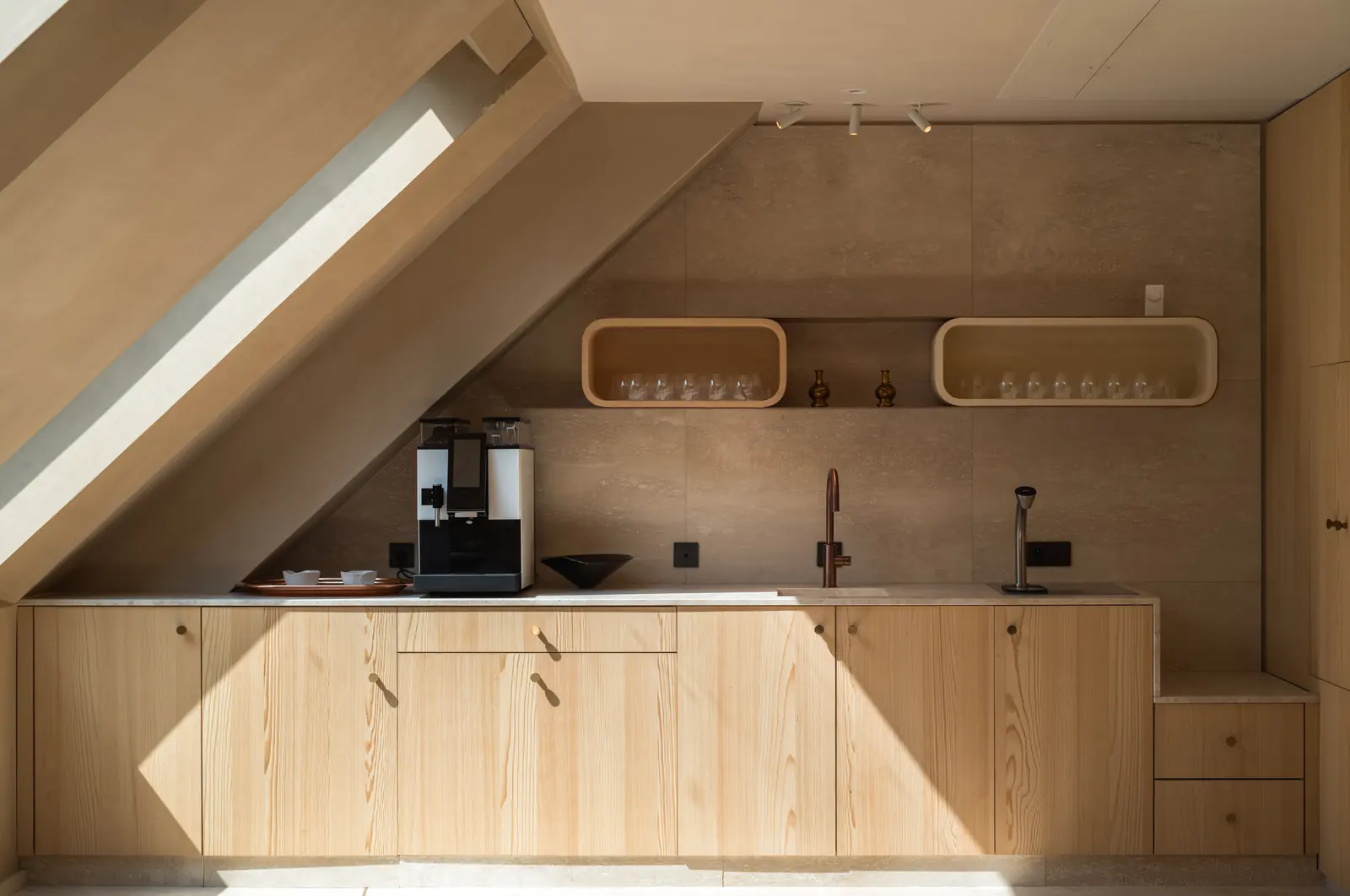 Oak kitchenette under a sloping skylight