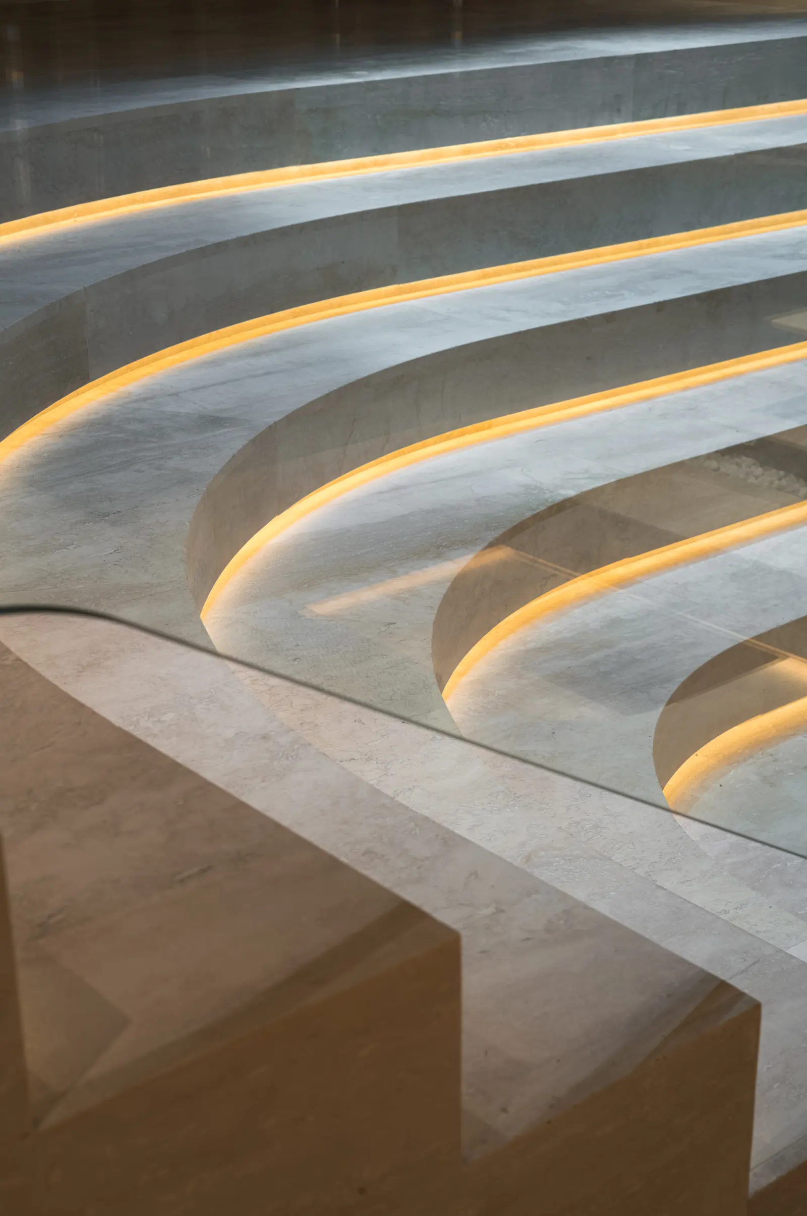 Curved stone steps with light strips in the spa