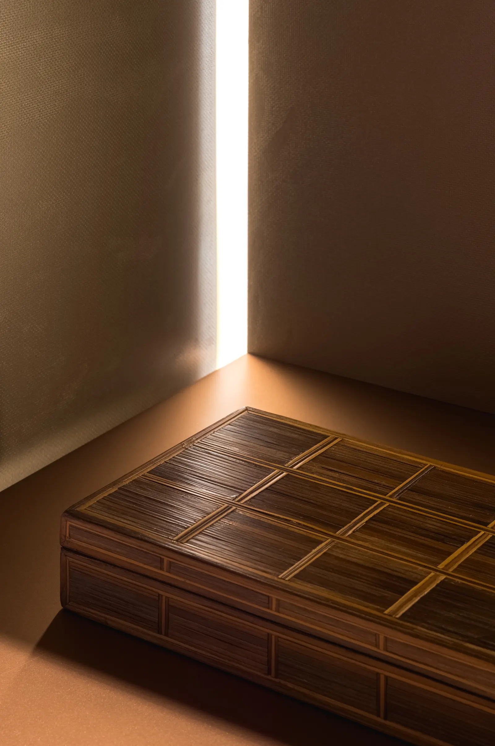 Wooden bench lit by a narrow slit of light