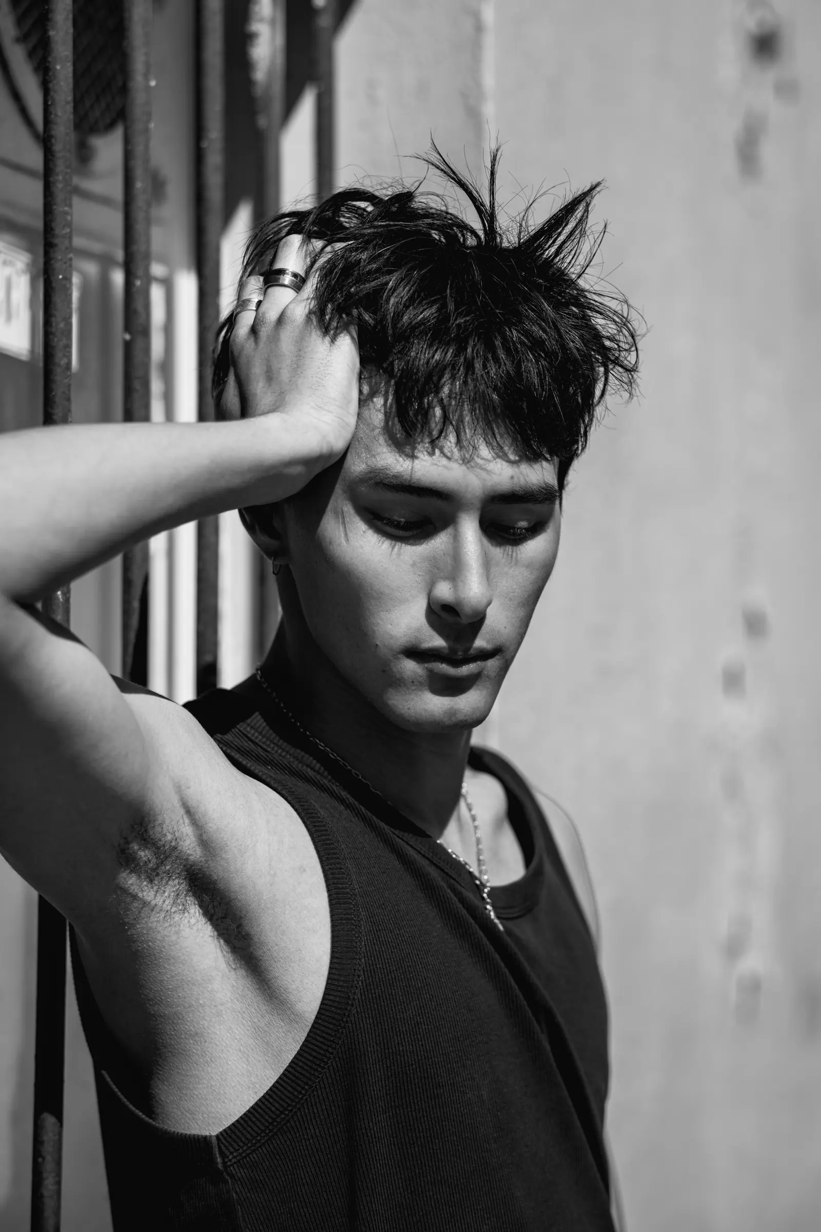 Man with a hand in his hair, in black and white